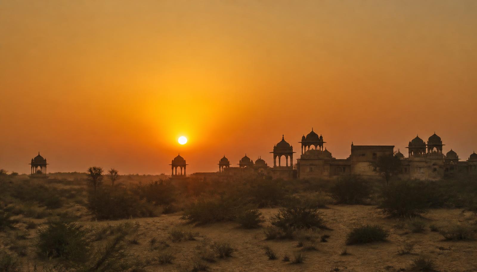 Chhatris silhouetted against a desert sunset near Mandawa